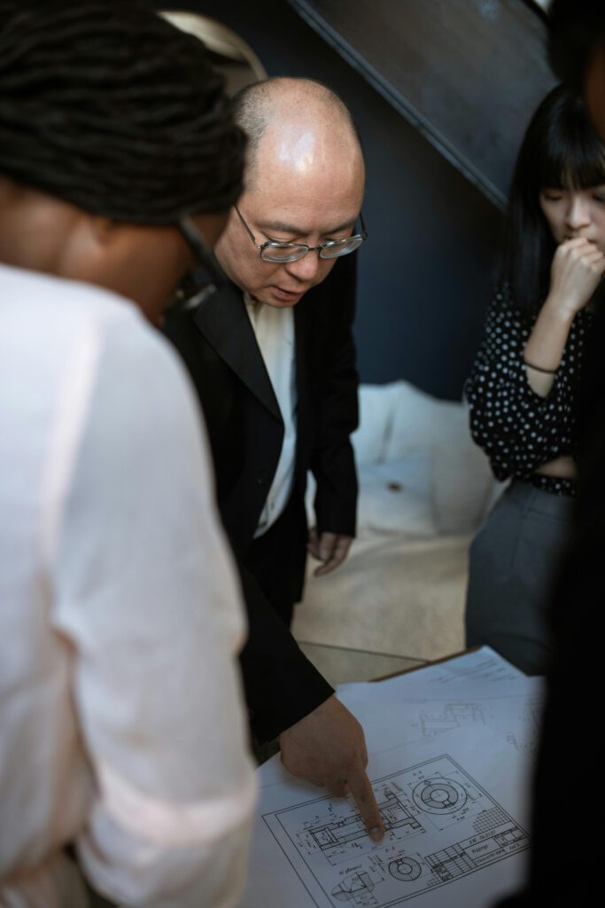 A Man in Black Suit Jacket Wearing Black Framed Eyeglasses